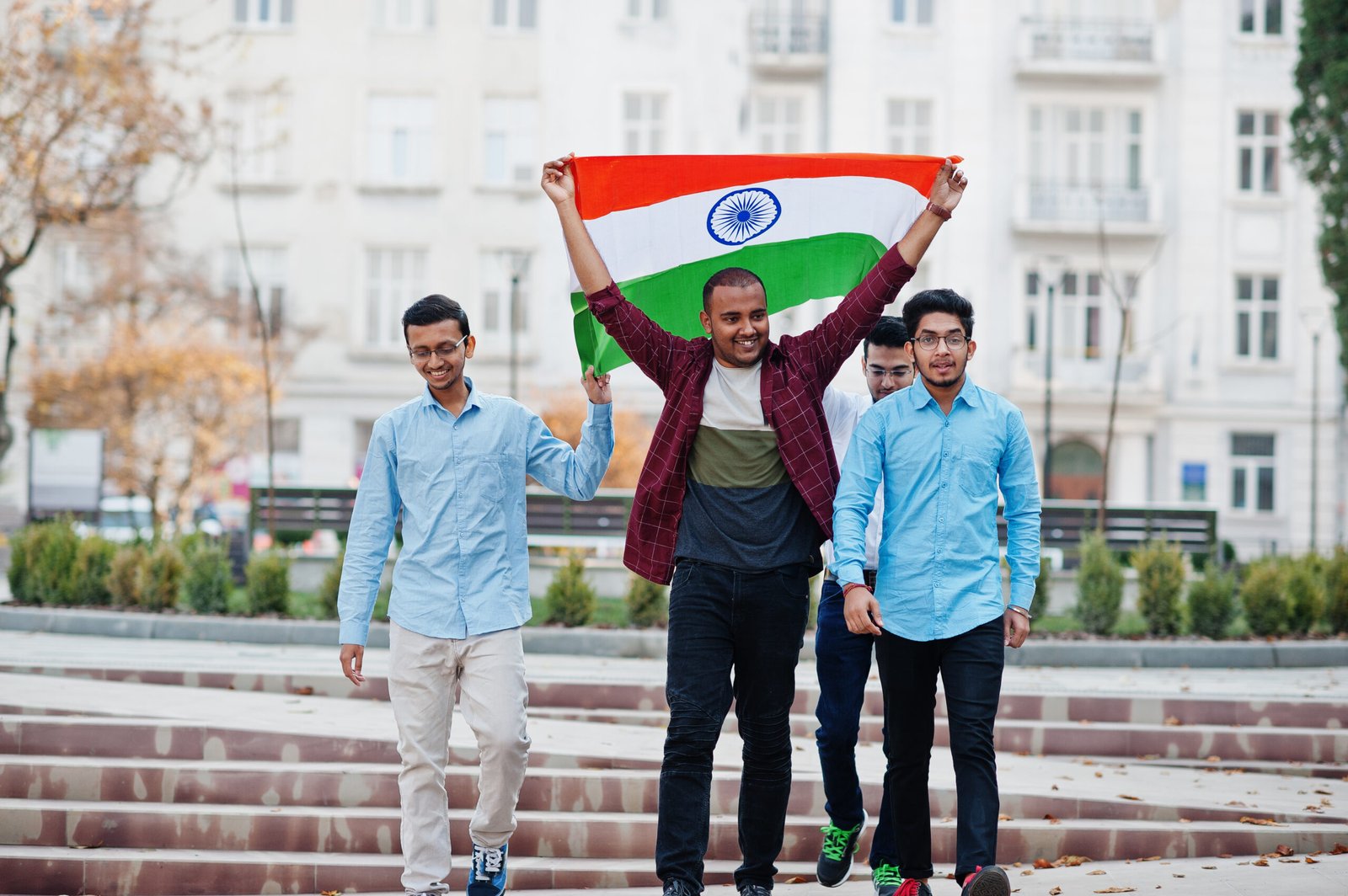 Group of four south asian indian male with India flag.